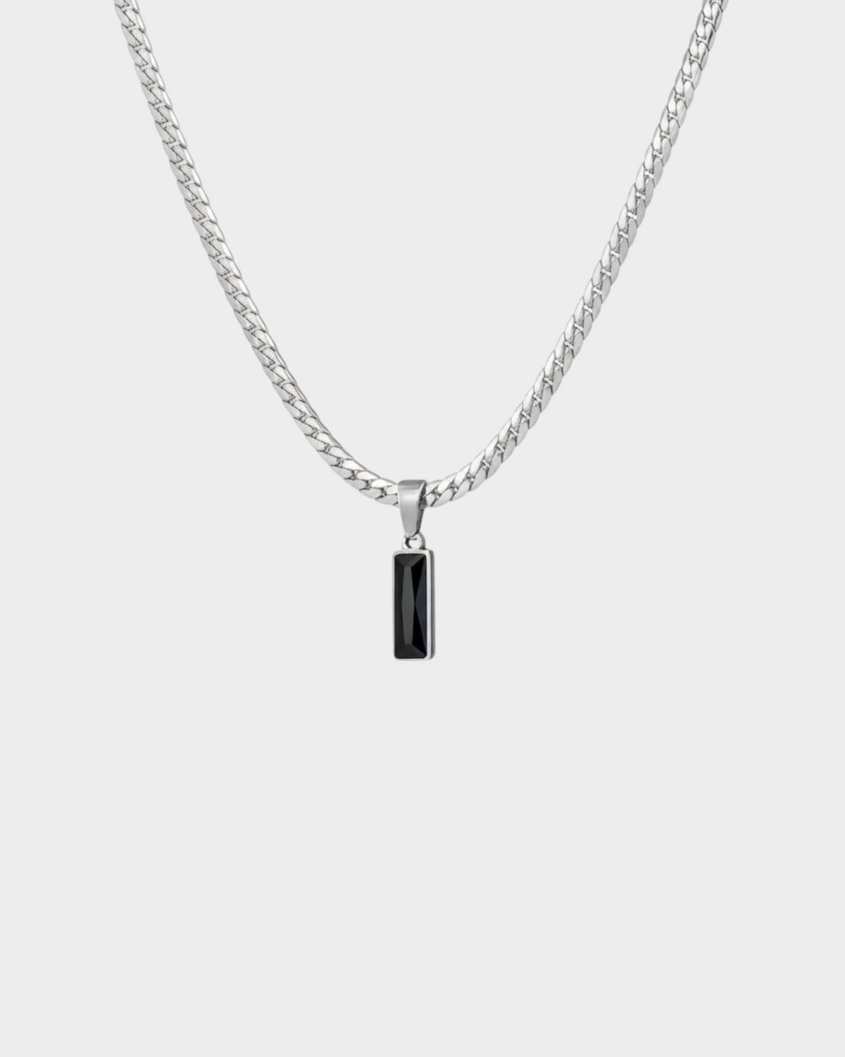 SIEVRA Baton pendant necklace featuring a vertical stainless steel bar with a black crystal inlay on a curb chain.