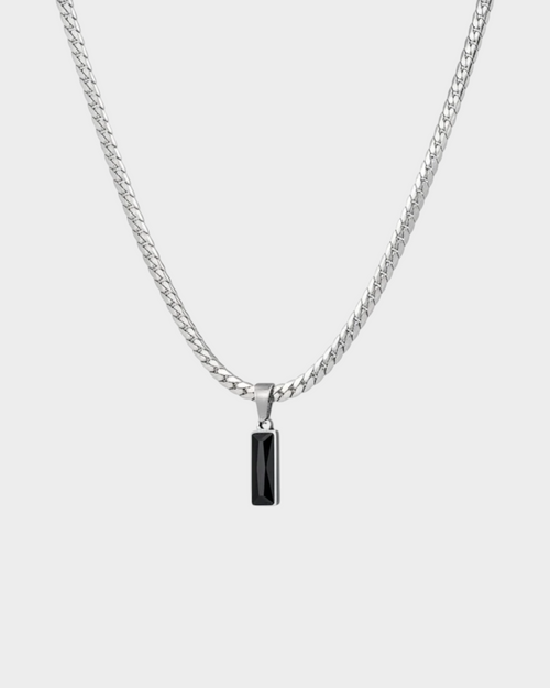 SIEVRA Baton pendant necklace featuring a vertical stainless steel bar with a black crystal inlay on a curb chain.