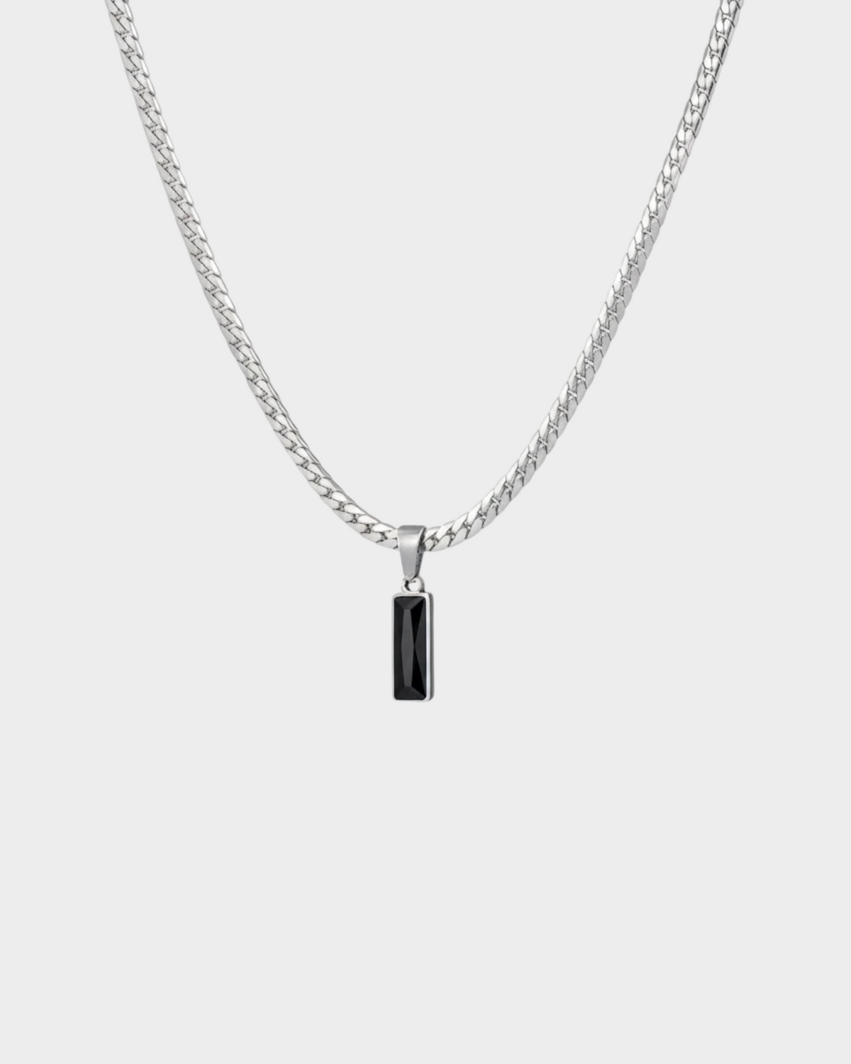 SIEVRA Baton pendant necklace featuring a vertical black crystal bar on a silver stainless steel curb chain