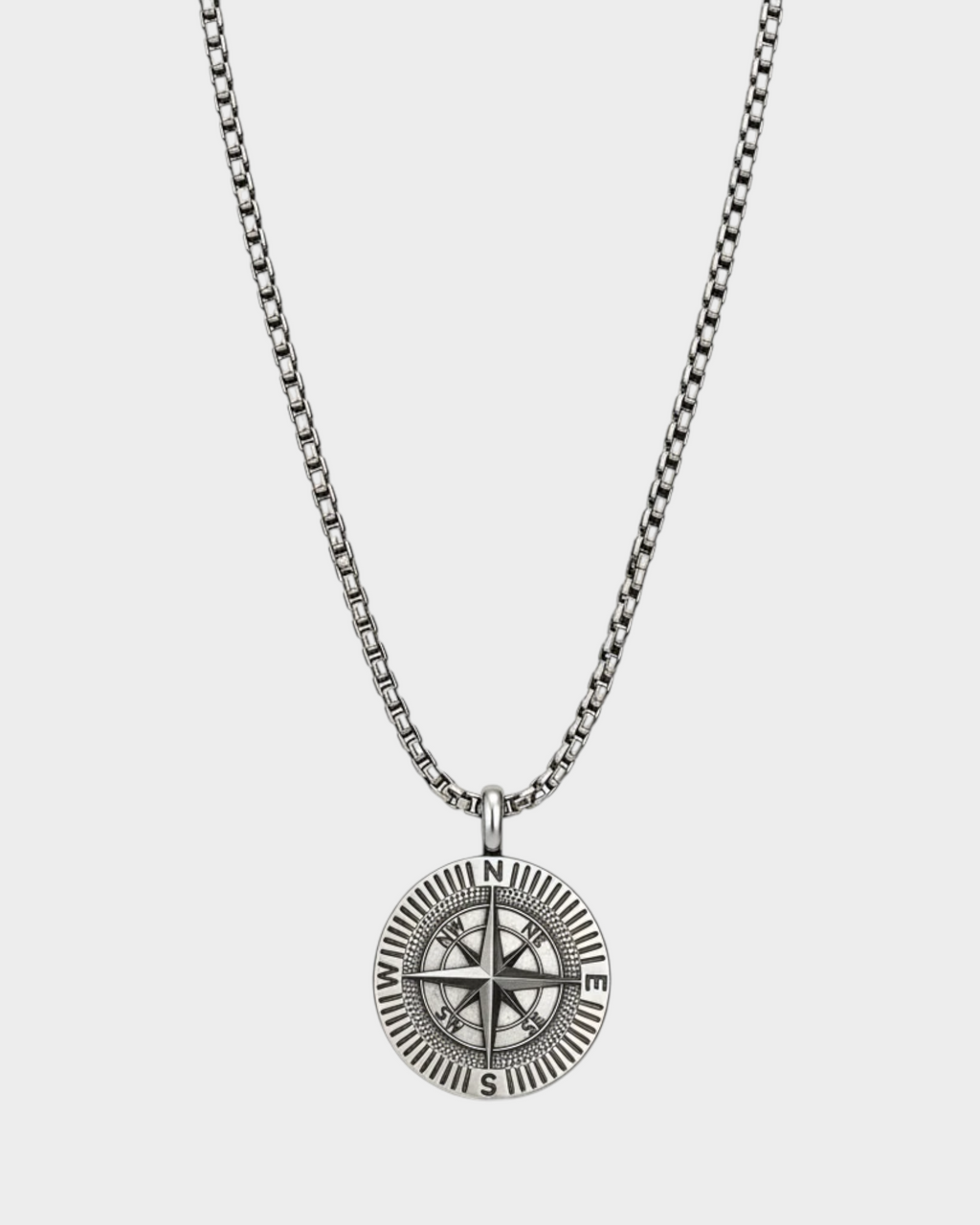 SIEVRA Bearing pendant necklace featuring a stainless steel compass medallion on an adjustable Cuban curb chain