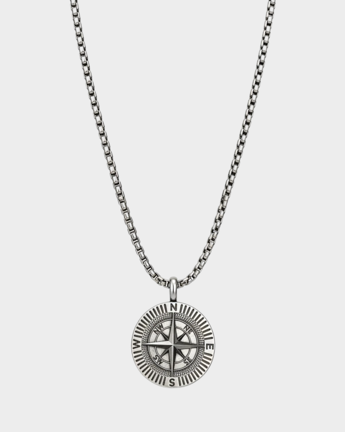 SIEVRA Bearing pendant necklace featuring a stainless steel compass medallion on an adjustable Cuban curb chain