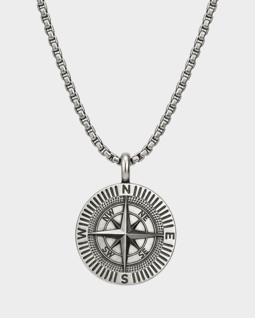 SIEVRA Bearing pendant necklace featuring a stainless steel compass medallion on an adjustable Cuban curb chain.