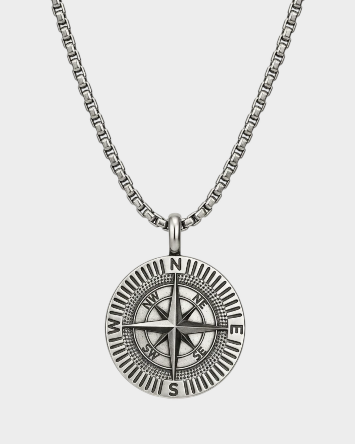SIEVRA Bearing pendant necklace featuring a stainless steel compass medallion on an adjustable Cuban curb chain.