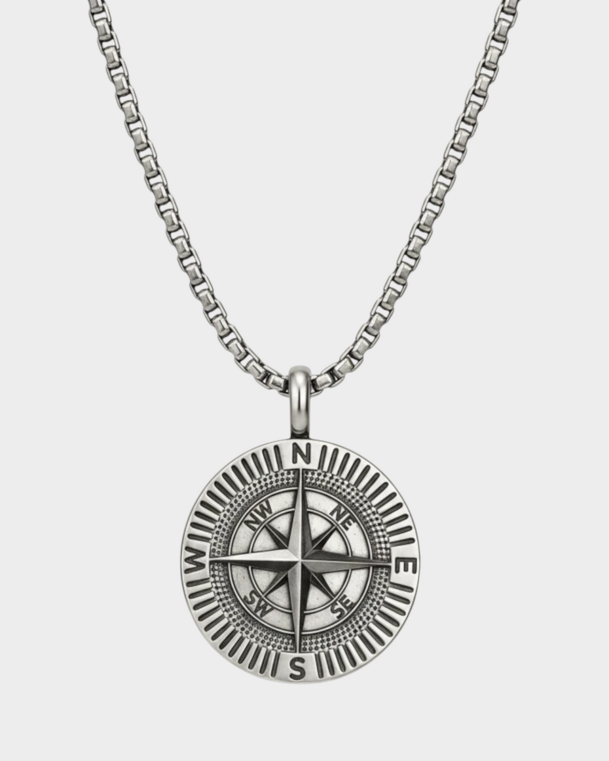 SIEVRA Bearing pendant necklace featuring a stainless steel compass medallion on an adjustable Cuban curb chain.