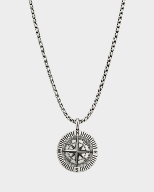 SIEVRA Bearing pendant necklace featuring a stainless steel compass medallion on an adjustable Cuban curb chain.