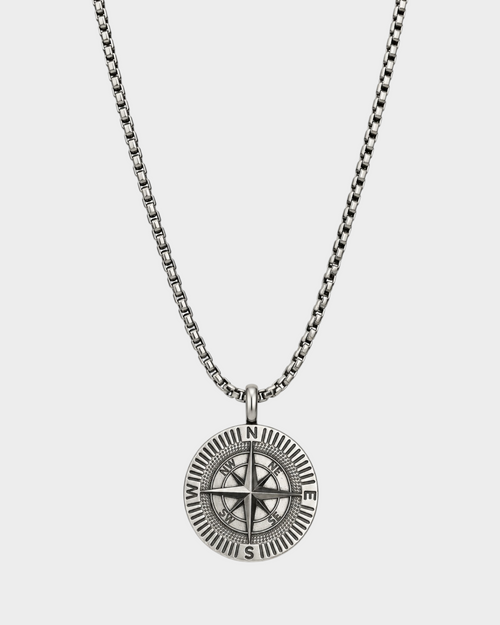 SIEVRA Bearing pendant necklace featuring a stainless steel compass medallion on an adjustable Cuban curb chain.