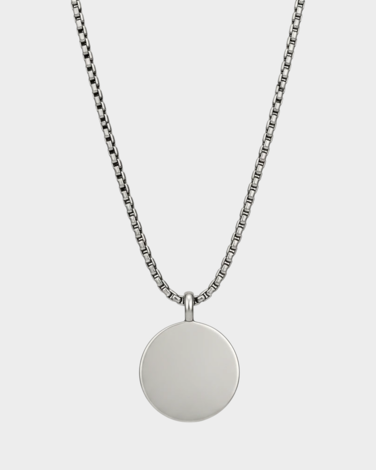 SIEVRA Bearing pendant necklace featuring a round compass-face medallion on a silver stainless steel curb chain.