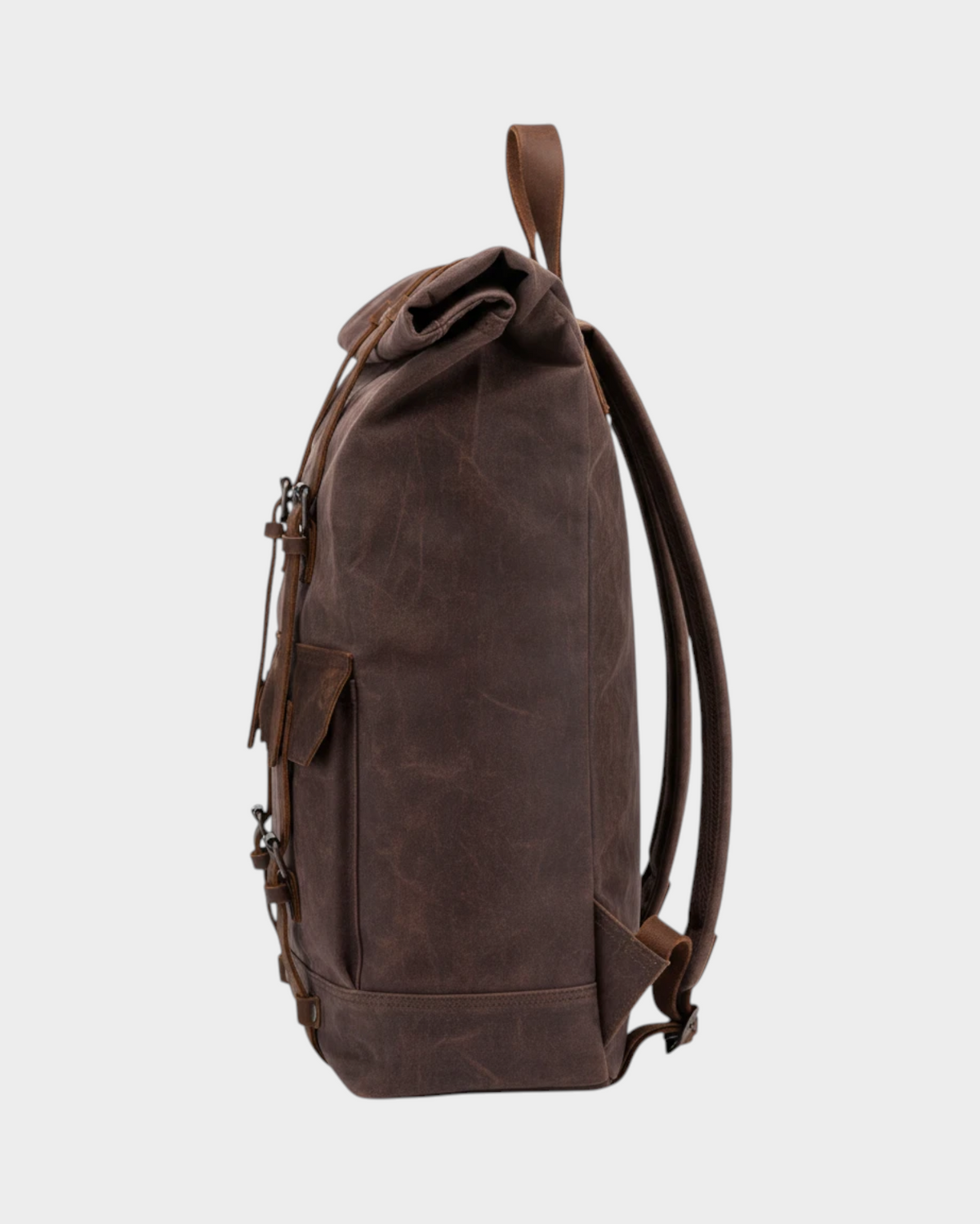 SIEVRA brown oil wax canvas roll-top backpack with genuine leather straps and trim, side profile view.