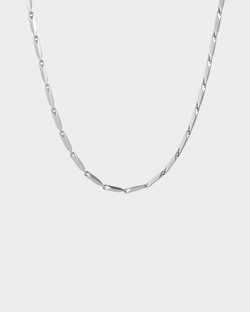 SIEVRA Facet Necklace featuring diamond-cut geometric stainless steel links that catch light on a white background