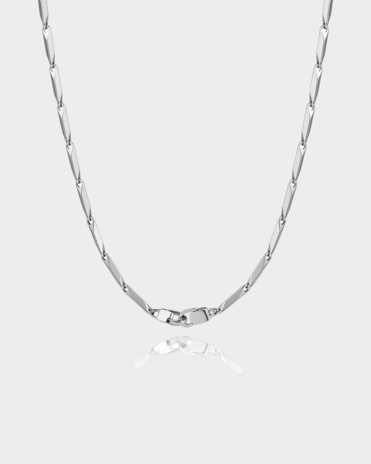 SIEVRA Facet Necklace featuring diamond-cut geometric stainless steel links that catch light on a white background
